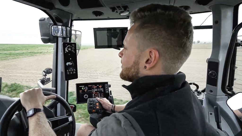 A farmer driving a tractor on the field and using integration to CO2 Calculator